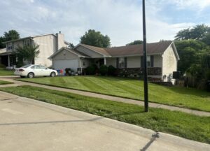 Freshly mowed green lawn with crisp stripes after professional weekly mowing service in O'Fallon MO by Greenside Lawncare